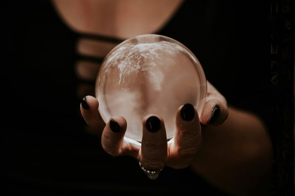 Woman's hand holding a crystal ball